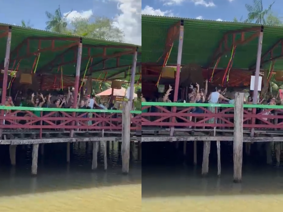 Moradores e turistas fazem o L e cantam música de Lula na Ilha do Combu, em Belém